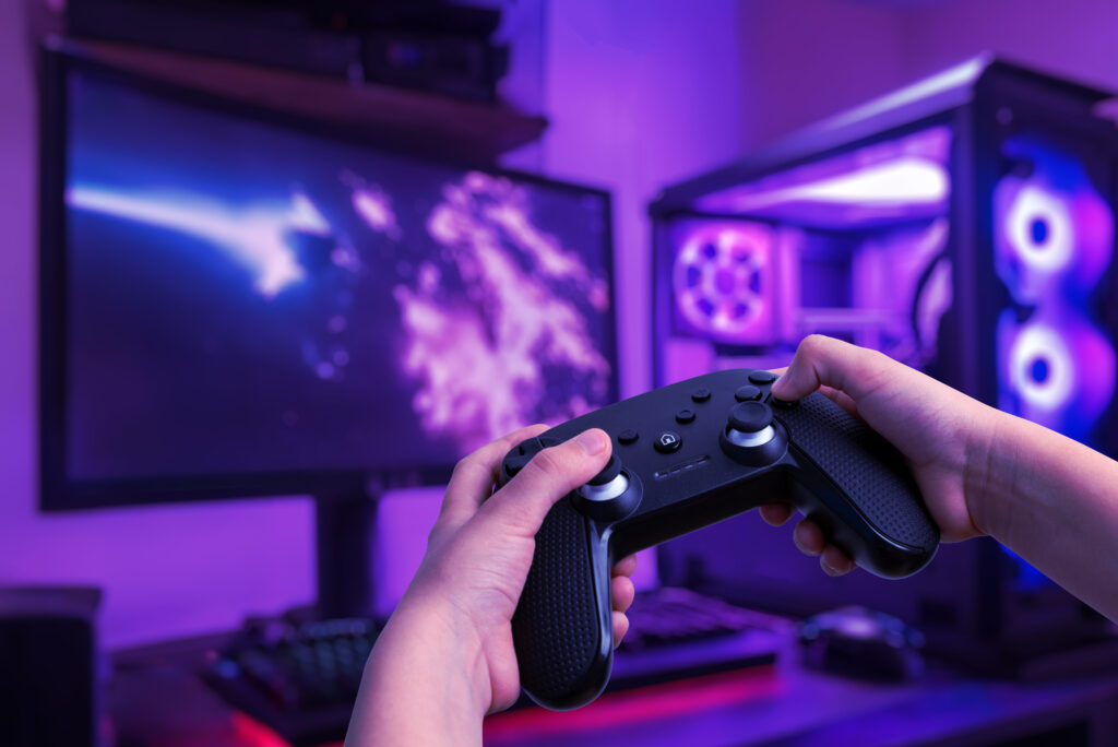 immersive-gaming-setup-featuring-gamer-playing-gaming-pc-with-gamepad-set-gamer-room-with-gaming-desk-led-lights
