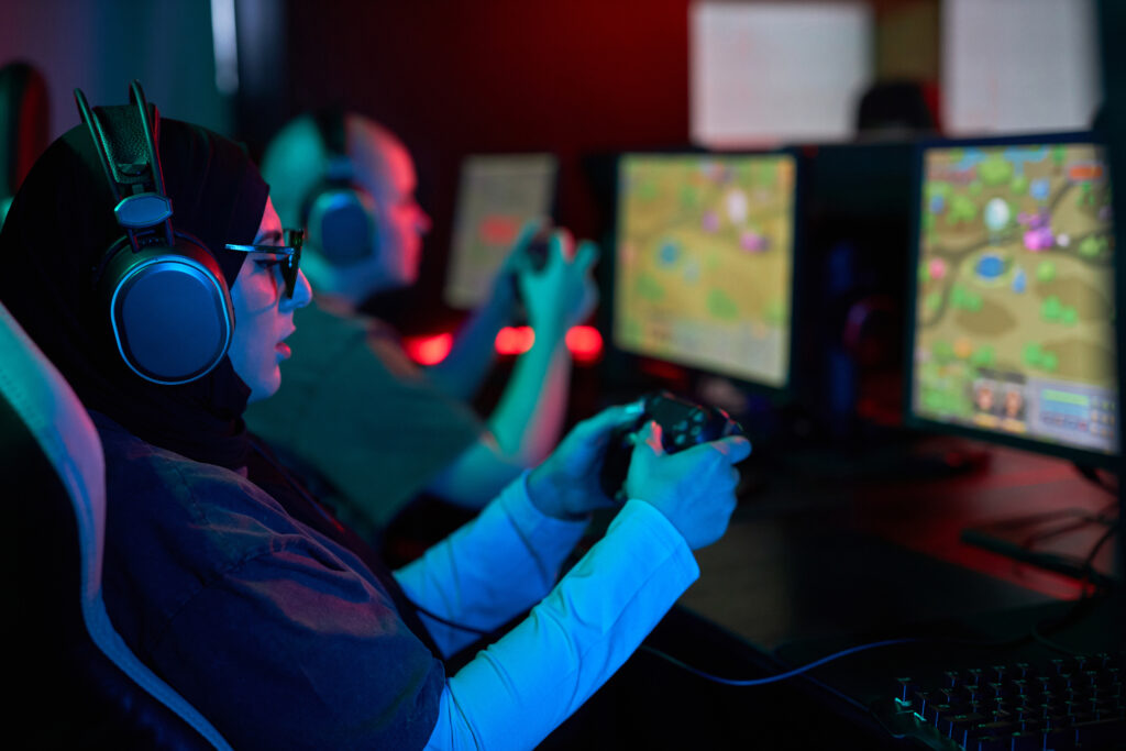 muslim-woman-playing-videogames-holding-gaming-controller